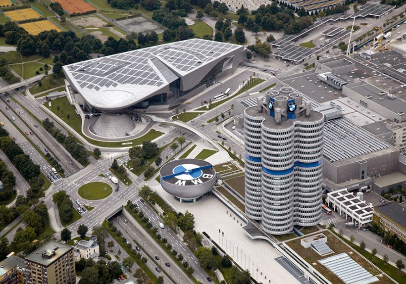 Das 100-jährige Stammwerk von BMW mit BMW Welt und der hoch herausragenden Konzernzentrale, die von Münchner:innen liebevoll der „Vierzylinder“ genannt wird Das 100-jährige Stammwerk von BMW mit BMW Welt und der hoch herausragenden Konzernzentrale, die von Münchner:innen liebevoll der „Vierzylinder“ genannt wird